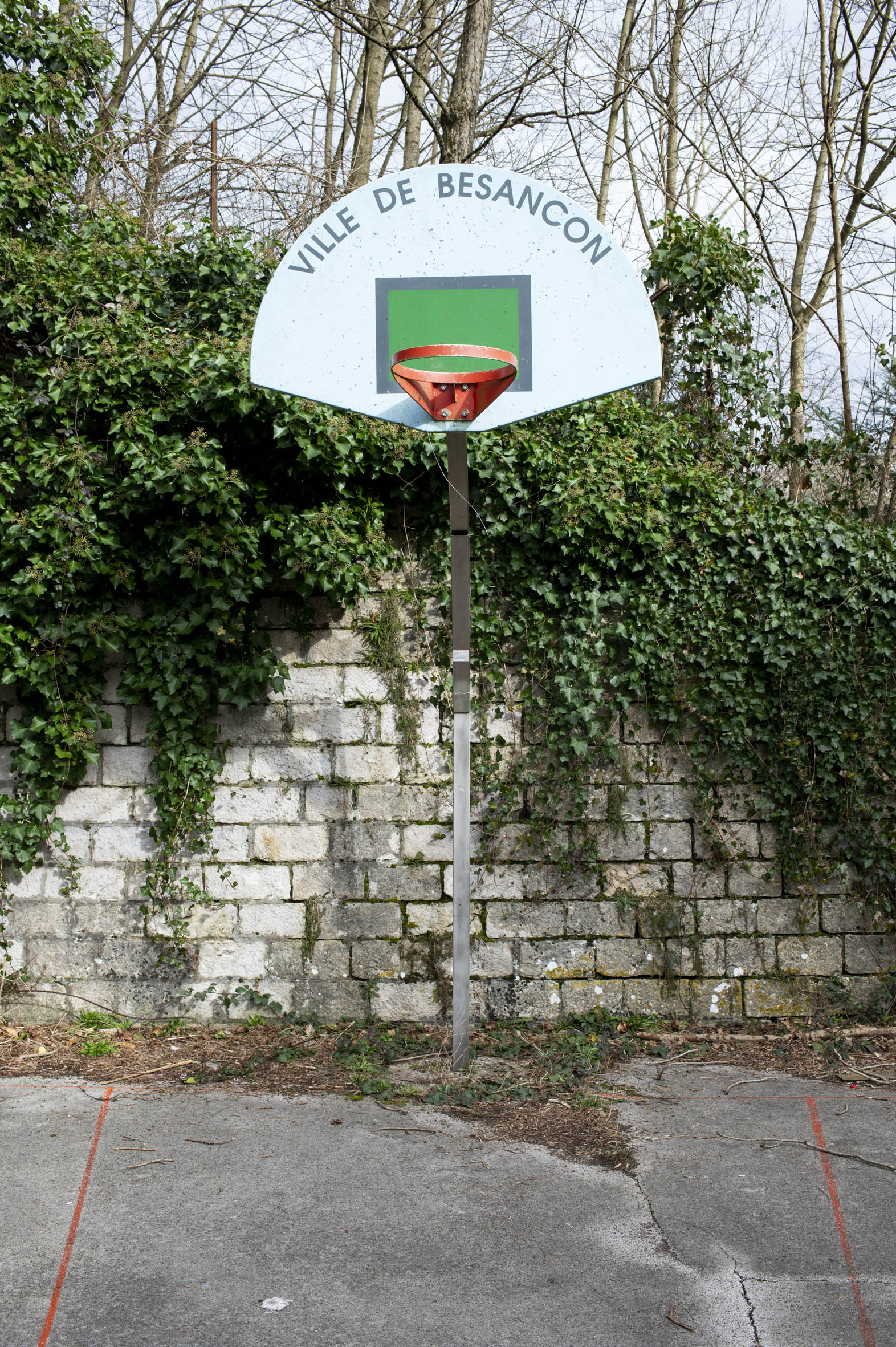 Photo d'un panneau de basket sur un terrain abandonné